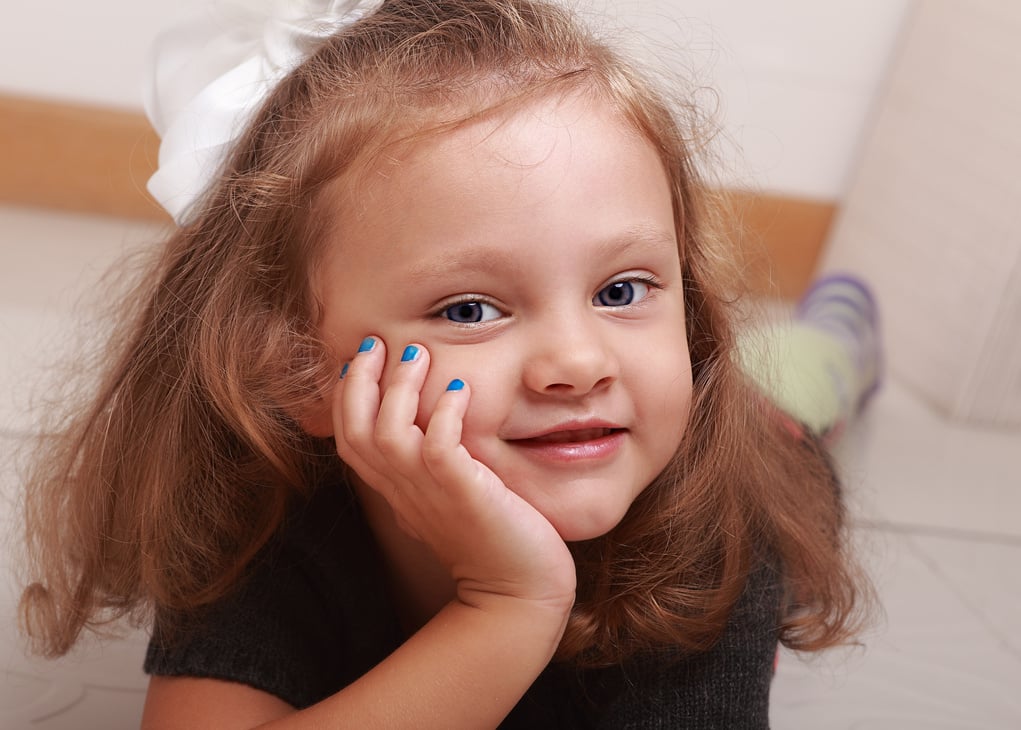 Beautiful cute kid girl smiling with manicured finger nails